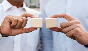 Business people holding cubes